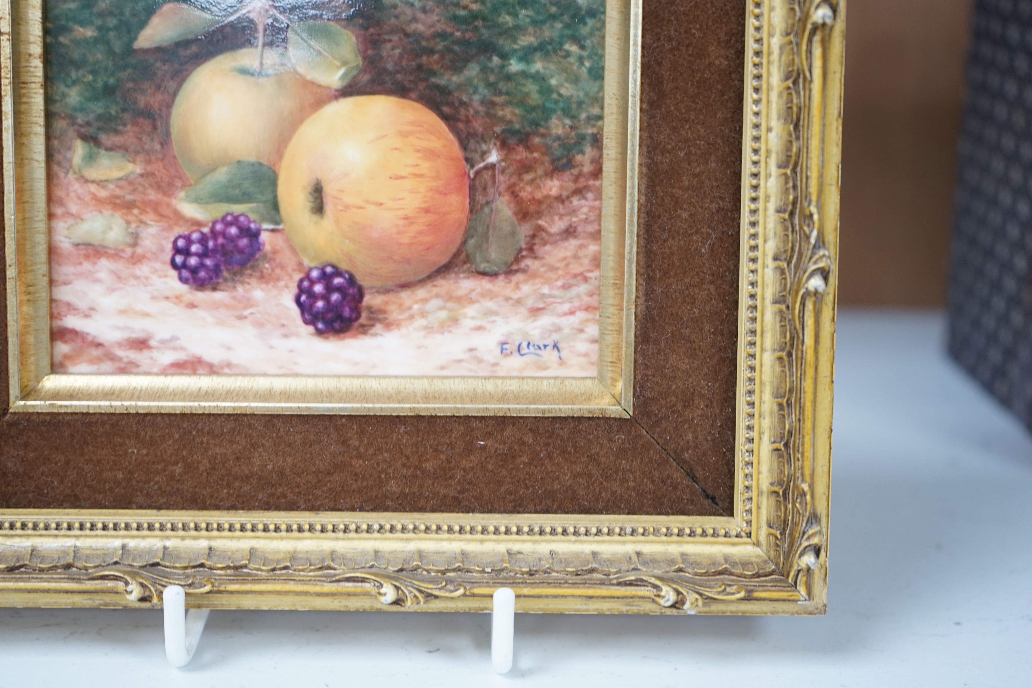 F. Clark (Royal Worcester artist, 20th. C), ceramic plaque, Still life of fruit, signed, 8 x 10.5cm, gilt framed. Condition - good